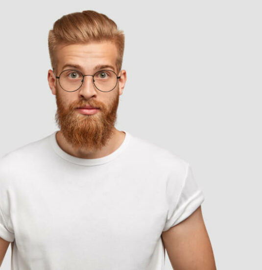 confident-ginger-man-with-trendy-hairstyle-wears-spectacles-looks-directly-1-1