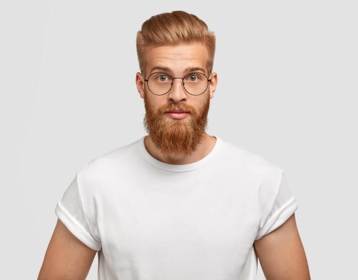confident-ginger-man-with-trendy-hairstyle-wears-spectacles-looks-directly-1-1